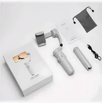 White and grey M1 handheld gimbal laid out with its box, drawstring pouch, grip and charging cable.
